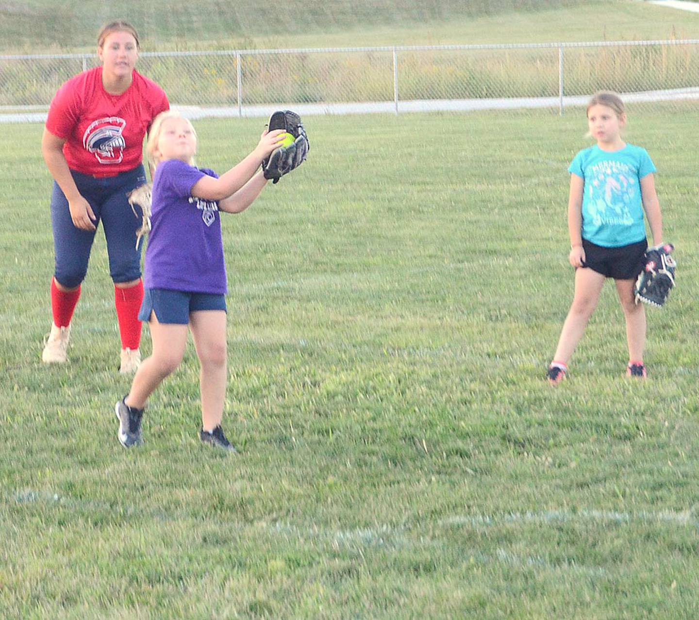 Raya Flaherty catches a pop fly during fielding and hitting skills clinic sessions at Monday's youth camp hosted by the Southwestern Community College softball team.