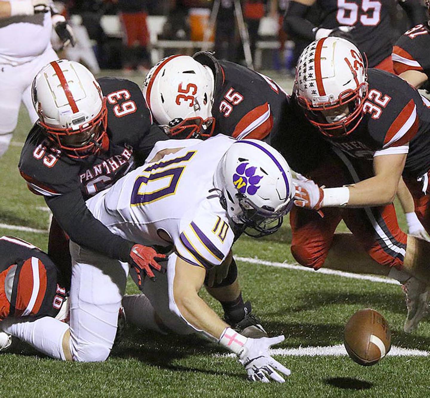 Noseguard Tom Mikkelsen (63), shown making a stop with a turnover against Nevada with senior linebackers Austin Evans (32) and Will Bolinger (35), is the lone returning starter in Creston's defensive line.