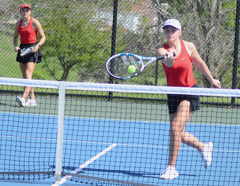 Creston's Sasha Wurster hits a volley at the net and as doubles partner Ava Adamson looks on during their victory over Atlantic Friday. Wurster and Adamson also won their singles matches.