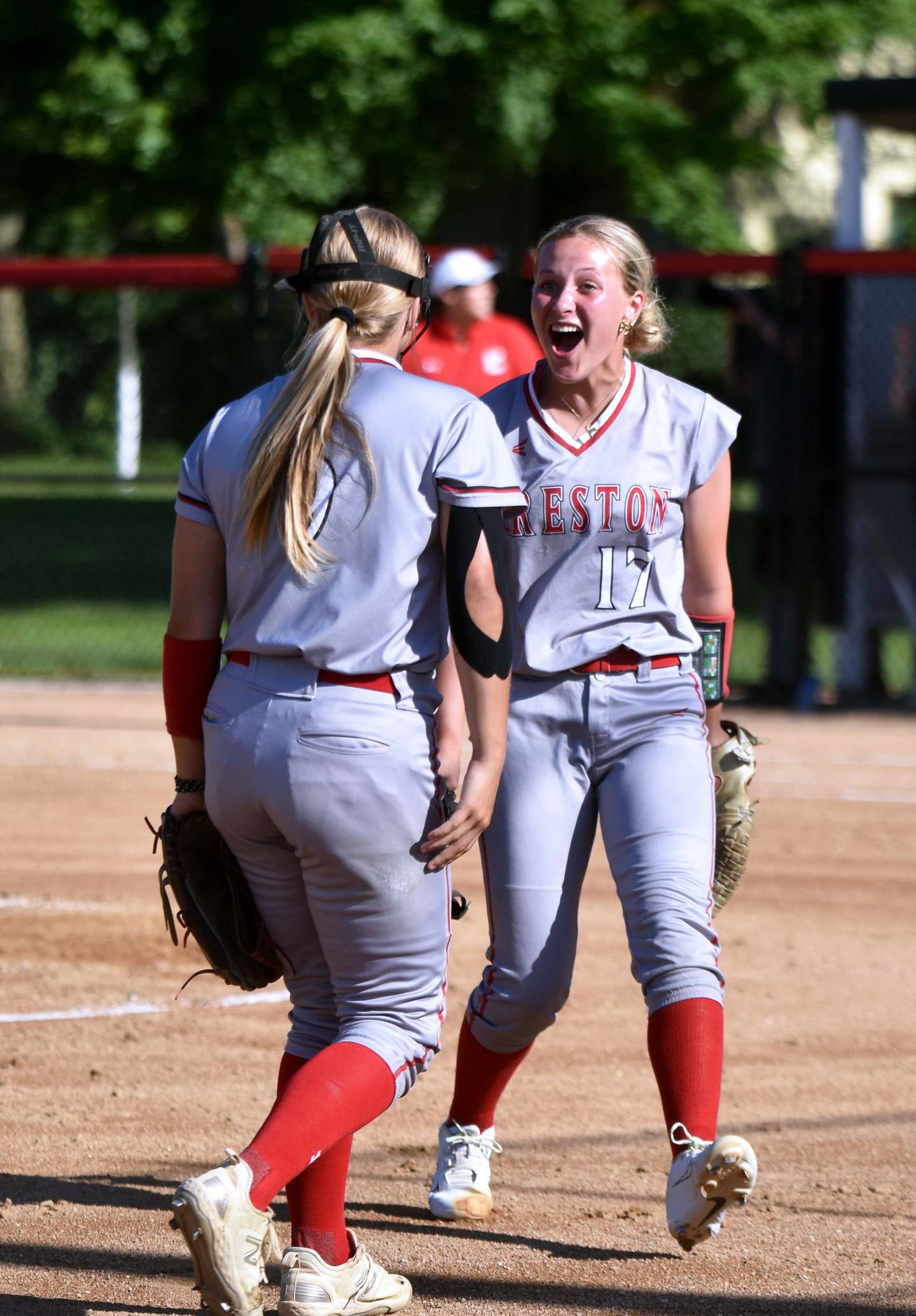 Pitcher Taryn Fredrickson, right, celebrates with third baseman Evy Marlin on her impressive double play in the second inning.