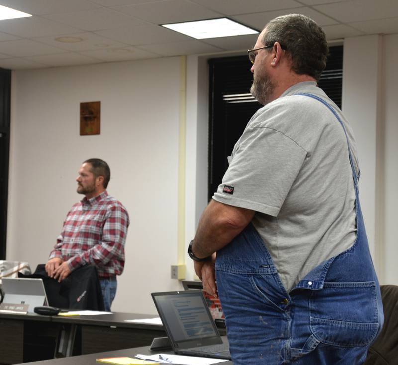 Creston School Board members Brad James (left) and Don Gee recite the oath of office as they enter another term.