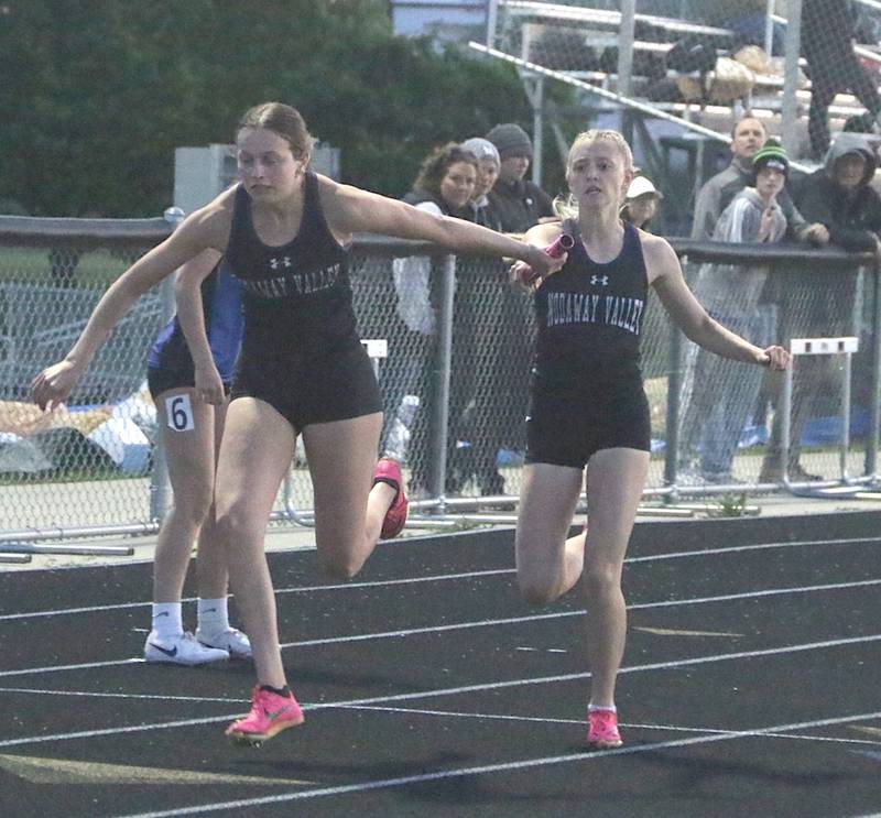 Maddie Weston hands off the baton to Emma Lundy during a relay at the state qualifying meet held in Mount Ayr Thursday, May 9.