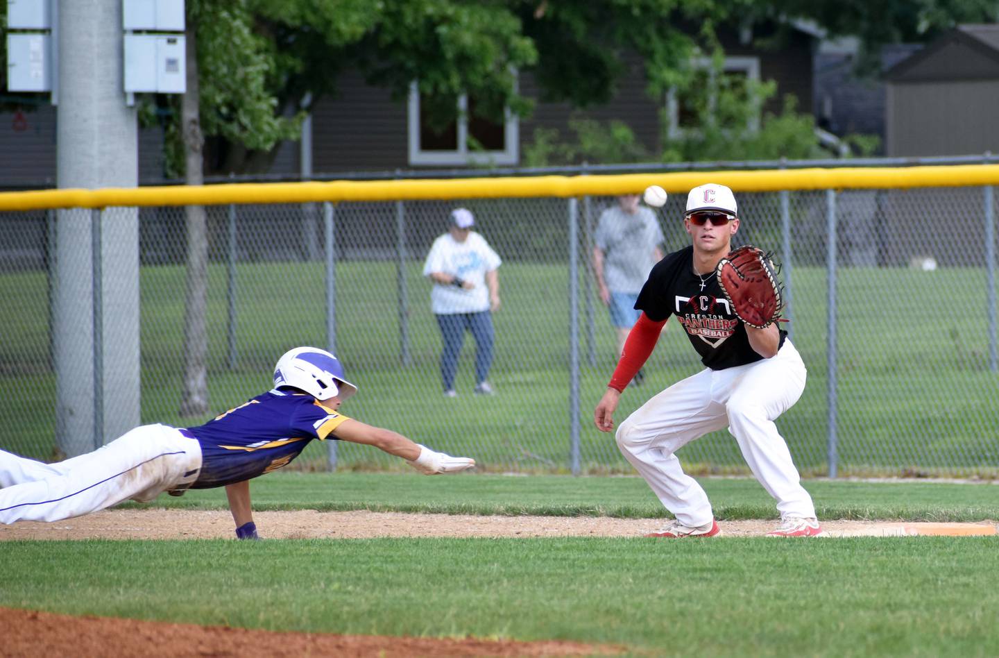Senior first baseman Sam Henry gets a ball from the pitcher trying to pick off a runner leading off first.