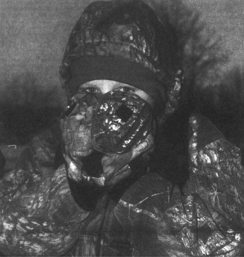 Aaron Johnson, 11, covers as much of his face as he can while waiting or a bus outside Lincoln School at 7:30 a.m. when the temperature was 14 below zero.