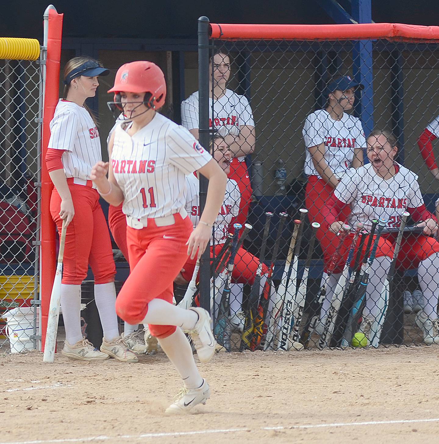 Southwestern's Kaitlyn Mitchell (11) scores on a single by Lily McCrae in Friday's 7-5 loss to Marshalltown. Mitchell had two hits in the game.