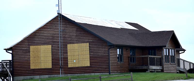 Boarded windows and coverings of the roof damage are visible at the Three Mile Lake Lodge after the April 26 tornadoes. County officials are interested in expanding the lodge size during repairs.
