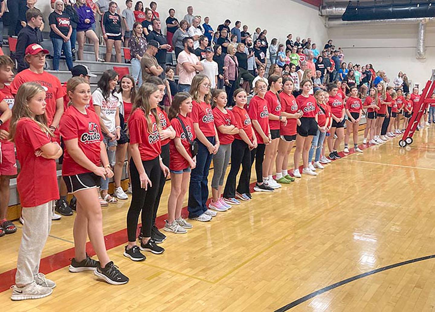 Creston youth volleyball players line the court during varsity introductions Thursday night as the Panthers hosted Red Oak.