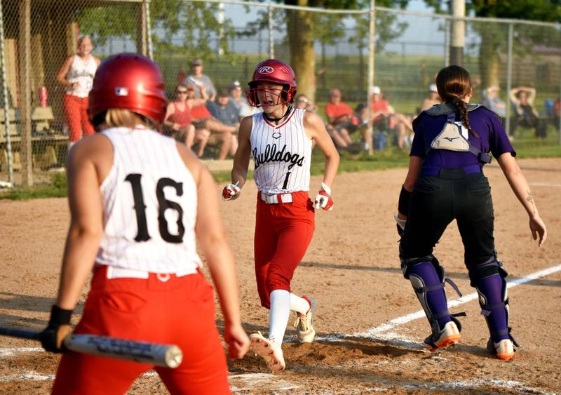 Freshman Marissa Cass crosses home plate after her in-the-park home run in the third inning while teammate Carter Osbourne celebrates. The homer drove in runs from Osbourne and Ella Boswell.
