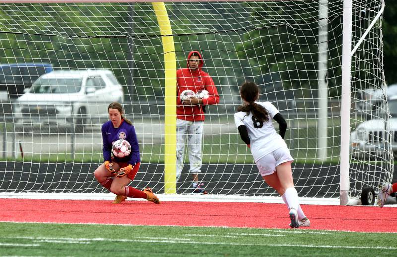Creston goalie Lea Stonebraker saves a shot on goal from Harlan senior Hailey Good Monday at home in the conference matchup. Good had two goals in the 10-0 Cyclones victory.