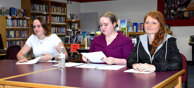 Orient-Macksburg High students Kasyn Shinn, Rogue Paxton and Bridget Bracy explain their research Tuesday about the options for the school district's future. Kinsey Eslinger also contributed to the work, but was not in attendance.