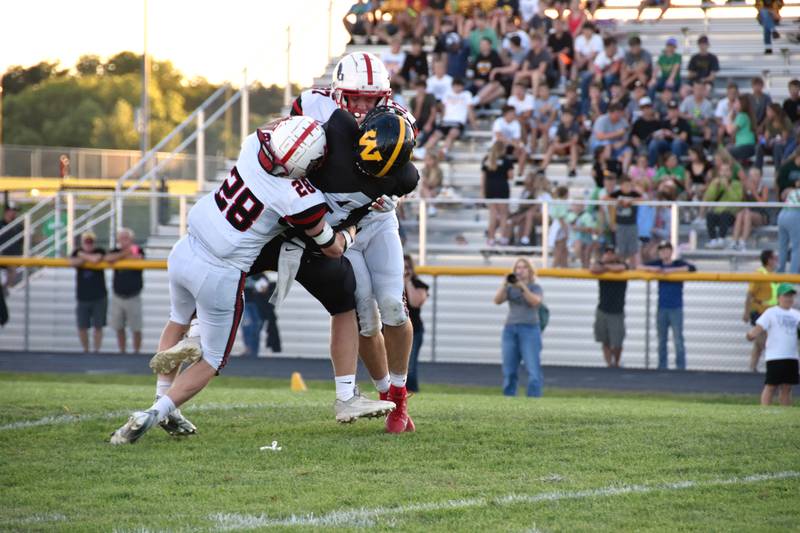 Creston’s Kal Barber (No. 28) and Lucas Travis take down Winterset quarterback Hunter Lyon in a 31-6 road loss to the Huskies Friday.