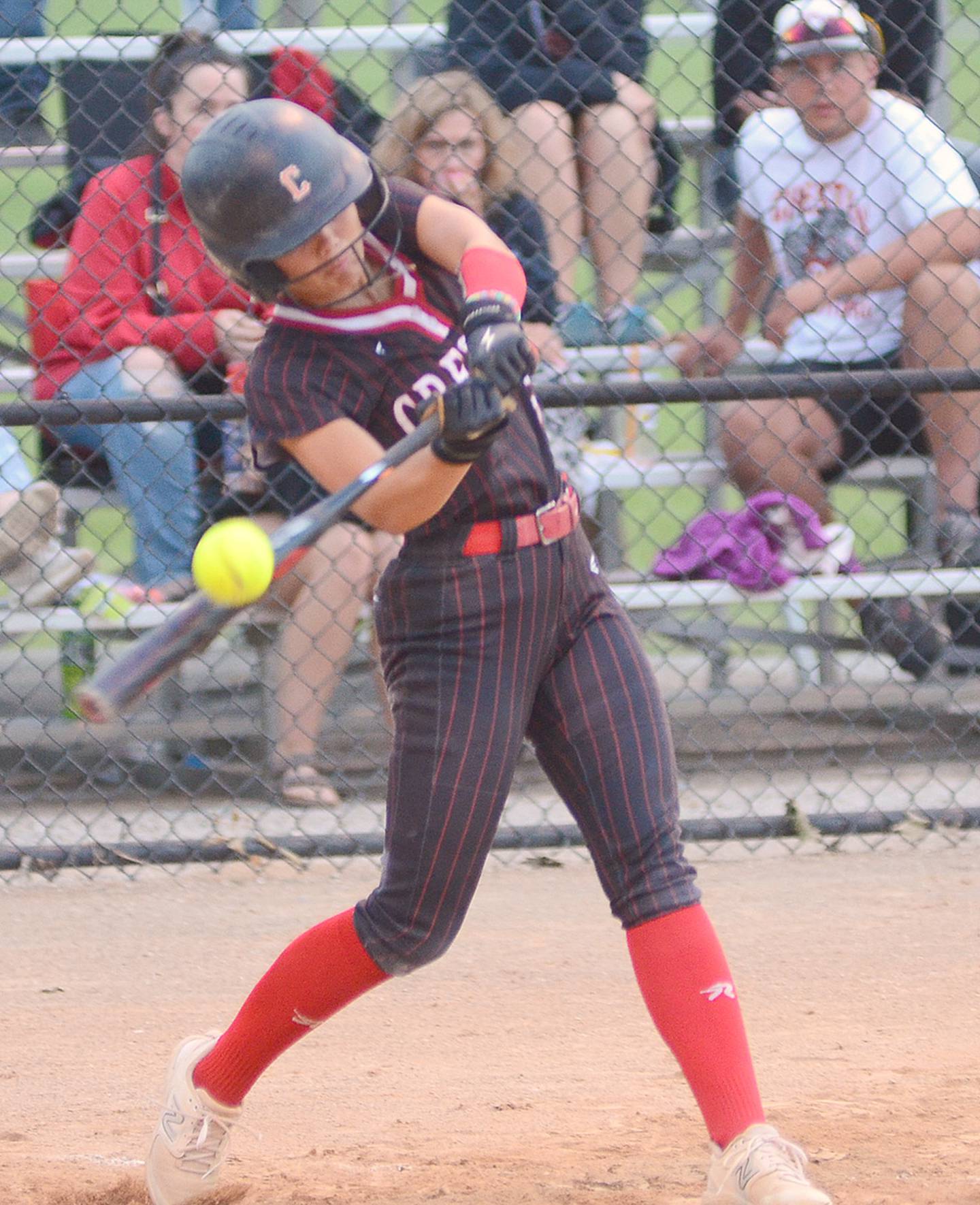 Creston's Ava Adamson connects with a pitch during Saturday's John Stephens Classic game against Earlham. Later in the game, Adamson delivered the winning RBI double in the ninth inning for the 6-5 victory.