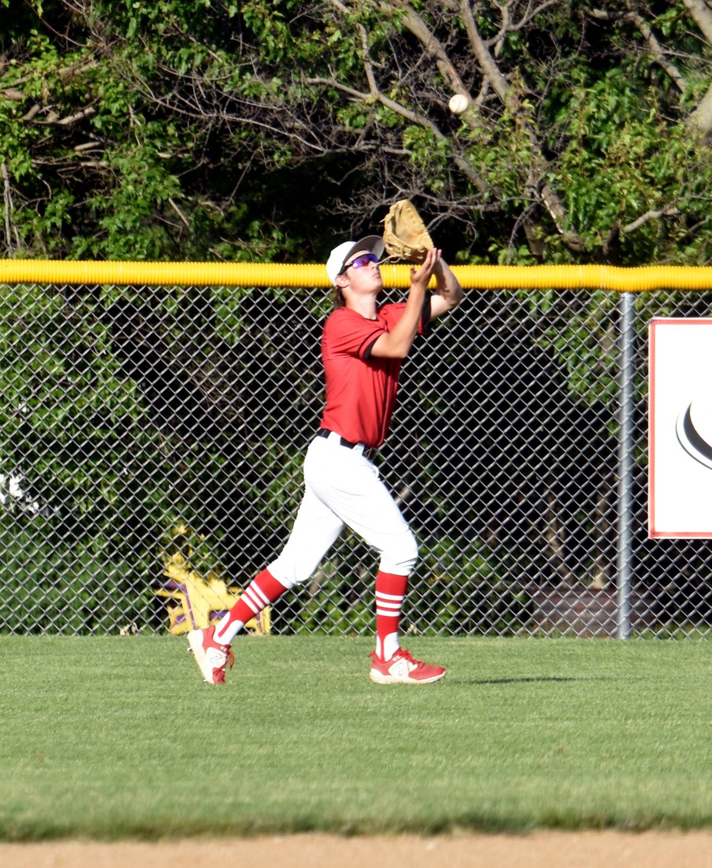 Senior centerfielder McCoy Haines catches a deep ball during the first game to end an inning