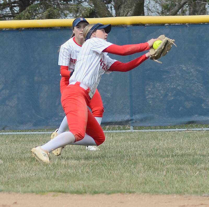 Southwestern shortstop Brooklyn Hadl reaches to catch a deep popup as left fielder Jayda Chew backs up the play during Friday's doubleheader against Marshalltown.