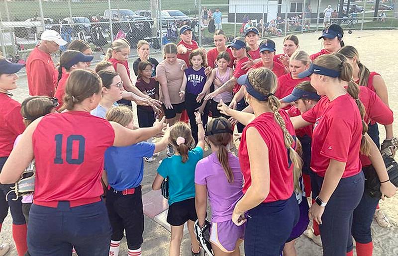 Participating youths in Southwestern's softball camp join the Spartan players in their traditional "Sparty Up" breakdown after the team's practice and youth camp Monday night.