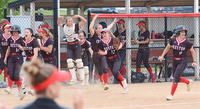 Baserunner Evy Marlin (9) and Creston teammates show their excitement after Taryn Fredrickson's two-run home run in the third inning against Glenwood Thursday.