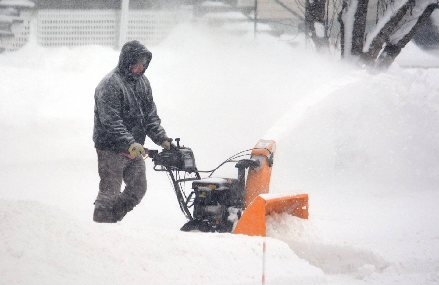 Todd Lamb of Greenfield snow blows a driveway along East Iowa Street in Greenfield during the height of the snow storm.