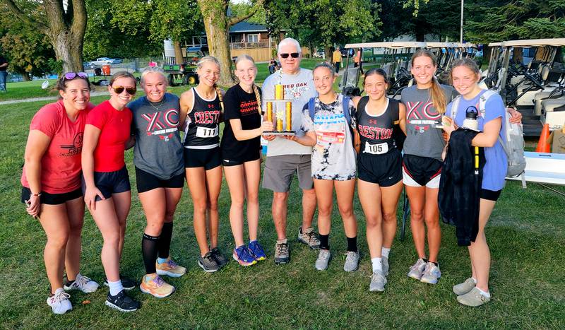 The Creston girls cross country team took home first place in the team contest at the Paul Fish Invitational in Red Oak. From left, Coach Maggie Arnold, Karter Clayton, Maylee Riley, Cora Smith, Reese Strunk, Paul Fish, Abby Freeman, Karlie Kruse, Payton Davis and Gretchen Hoepker.