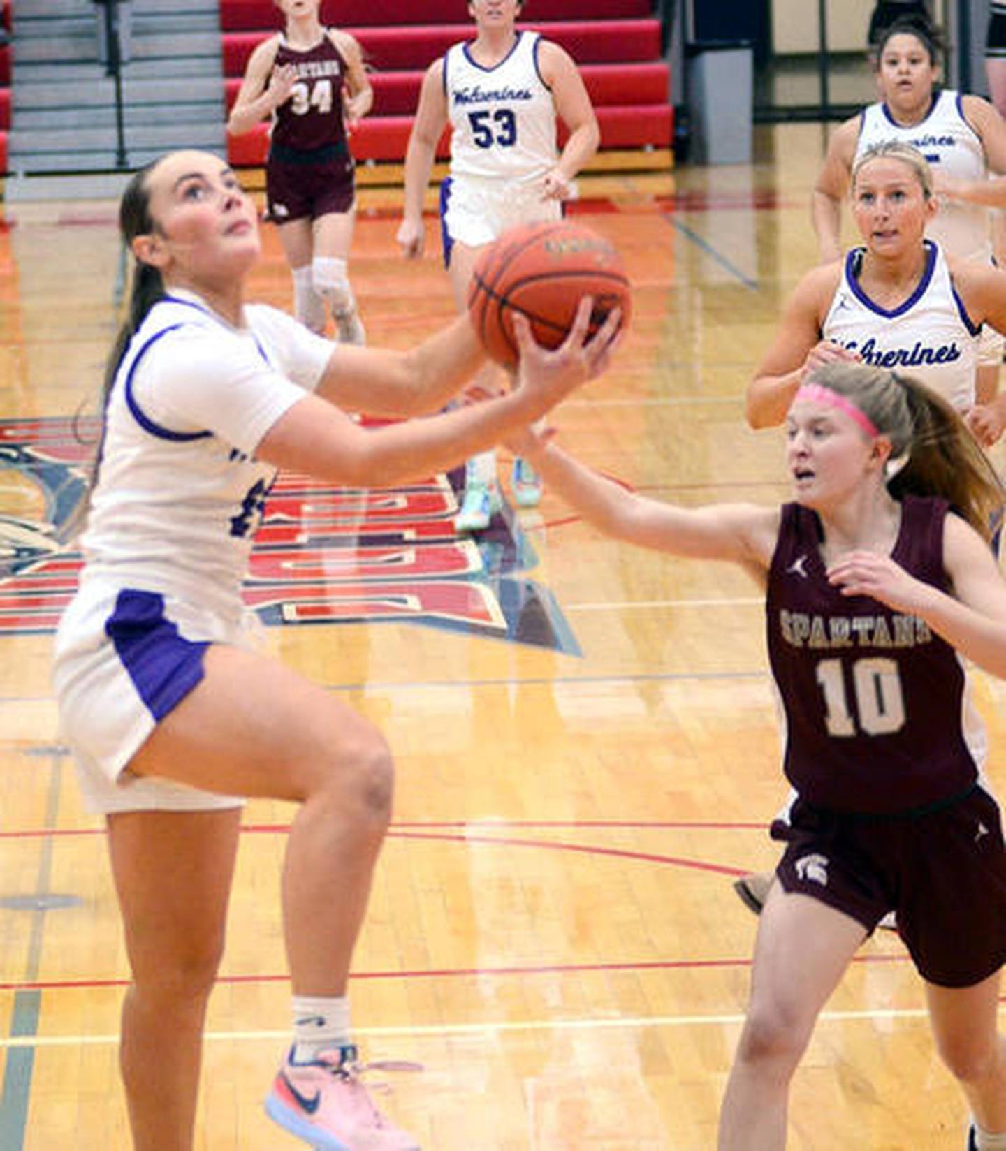 Lindsey Davis finishes on a fast break bucket during a regional final girls basketball game in February against Grundy Center at Ballard High School.