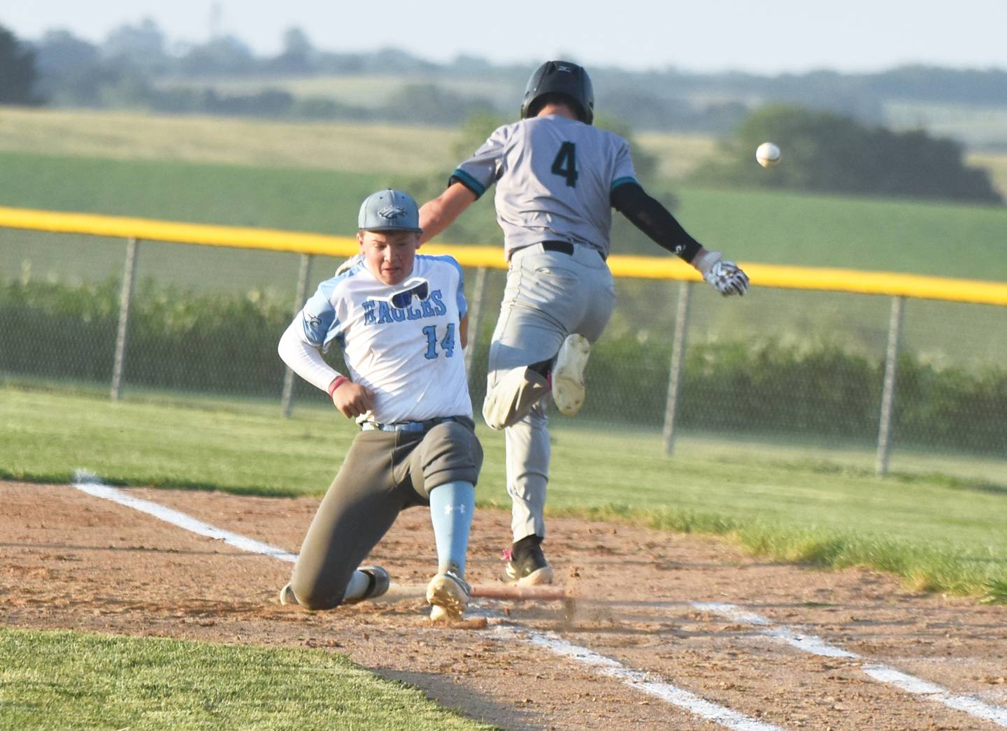 East Union first baseman Braden Kelley is hit by Southwest Valley runner Gavin Wetzel as he attempted to field the ball at first. There were numerous collisions throughout the game including Timberwolves’ Braden Maeder somersaulting out of bounds after a crash on his way to first base.