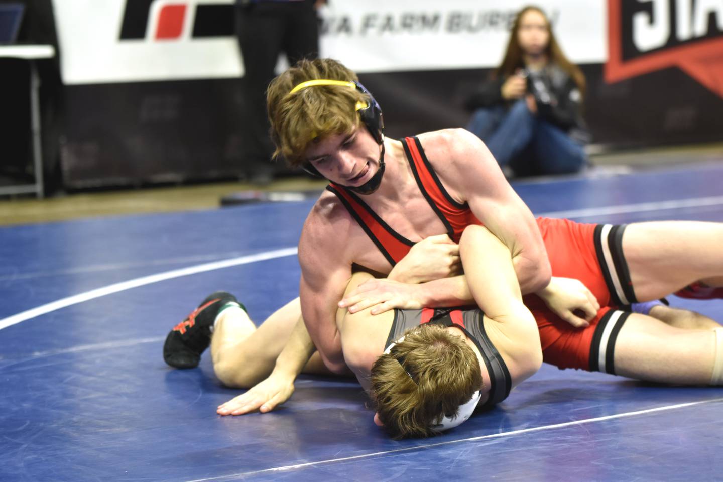 Christian Ahrens works to roll Isaac Wilson of Algona Friday at the IHSAA State Wrestling Tournament. Ahrens won the bout in a third-period pin before advancing to place fourth.