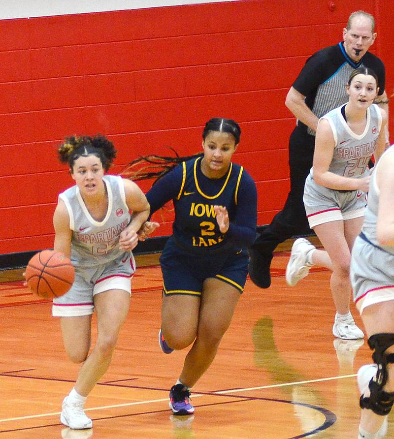 Southwestern guard Shyla Moore (left) advances the ball on a fast break against Iowa Lakes Saturday. Moore scored nine points in the 75-72 loss.