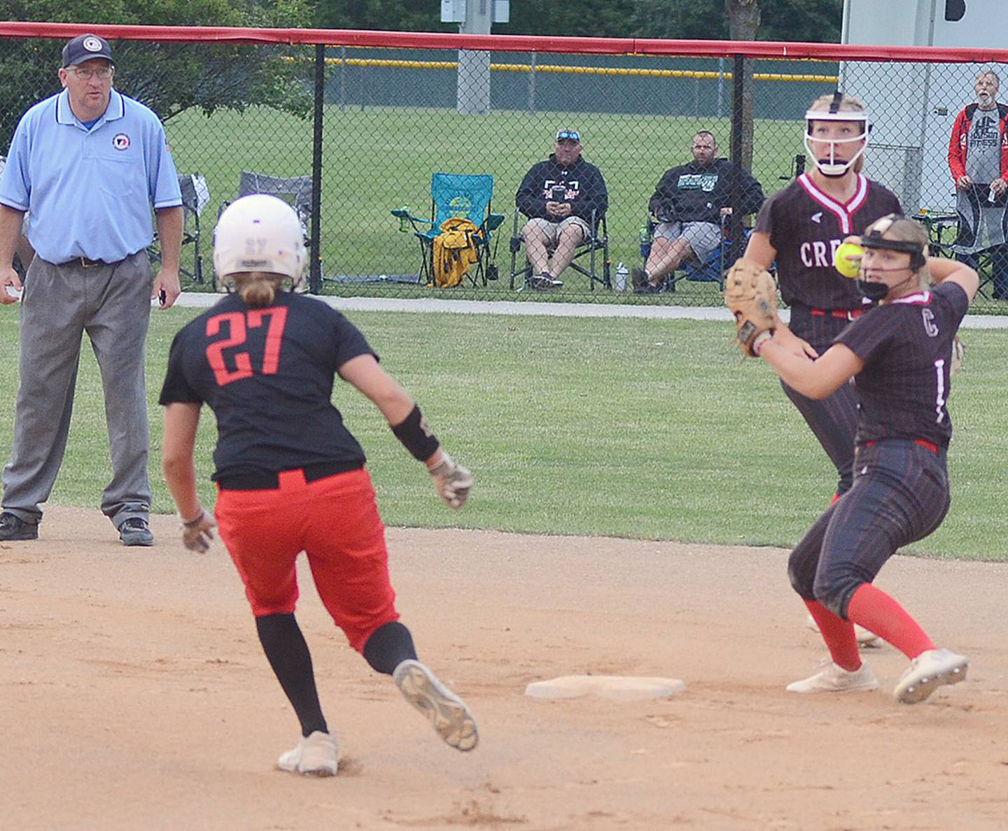 Creston second baseman Sophie Hagle throws to first base to complete a double play after receiving a toss from shortstop Avery Staver (behind Hagle) during Saturday's 6-5 win over Earlham. Hagle had a game-tying hit with two outs in the eighth inning to send the game to the ninth inning.