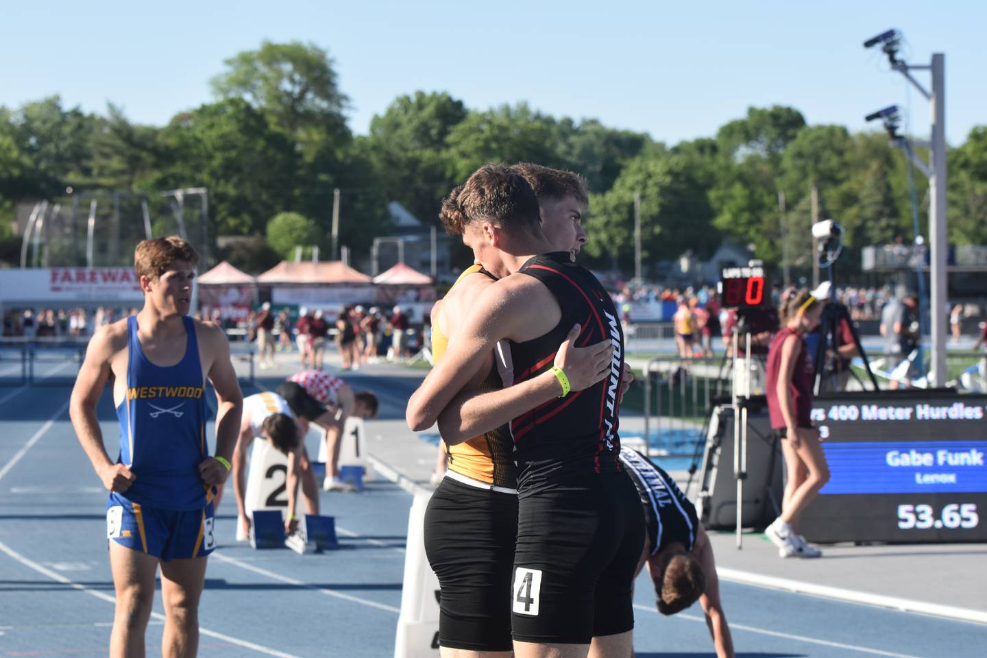 Gabe Funk and Ryce Reynolds, Pride of Iowa friendly rivals hug after placing first and second in the 400m hurdles.