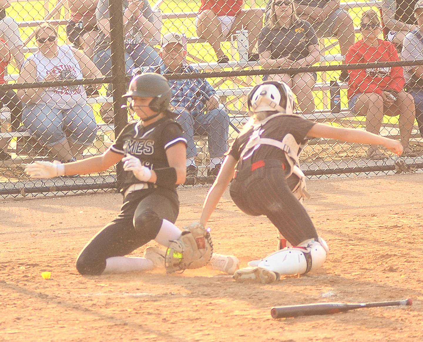 Camryn Johnson of Ames is tagged out at the plate by Creston catcher Ava Adamson after Adamson received a throw from center fielder Jersey Foote on a single by Lillie Galvin in Monday's opener. Foote also homered in the game and Adamson hit a triple off the top of the center field fence in the 12-4 loss.