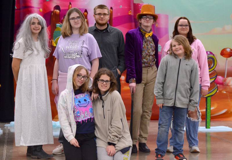 The cast of "Willy Wonka Jr.," some in costume. FRONT ROW: Vanessa Long (Mrs. Beauregarde), Elizabeth Folk (Violet Beauregarde), Colton England (Mr. Salt). BACK ROW: Peyton Cunningham (Grandma Josephine), Riley Cheers (Mrs. Bucket), Titus Stover (Mr. Bucket), Rae Elben (Willy Wonka), Reese Guiter (Veruca Salt).