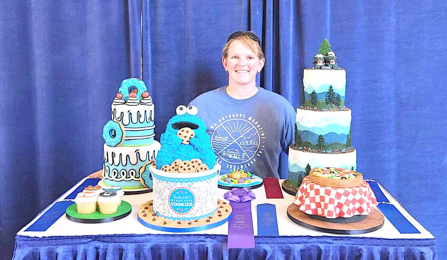 Katie Guisinger, who is the West Central Valley school resource officer, displays her cakes and ribbons won during the Iowa State Fair.