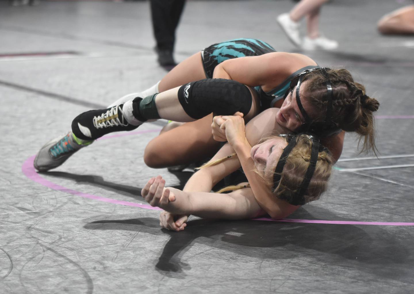 Maddie McCoy (110) of Southwest Valley holds Rylee Rice of WACO in a cradle during the second round. McCoy won the match in a second-period pin.