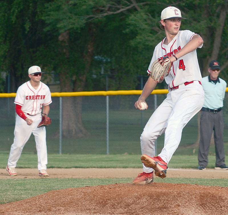 Senior pitcher Cael Turner delivers a pitch against Clarinda Thursday evening. First baseman Sam Henry is at left. Turner and Clarinda starter Karsten Beckel each allowed just one run until the Cardinals rallied in the seventh for a 3-1 victory.