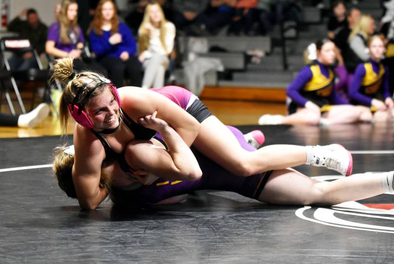 Evy Marlin (130) earns back points Thursday on Andrea Taylor before getting the pin early in the second period. Highway 34 topped Indianola 54-12 in the home dual.