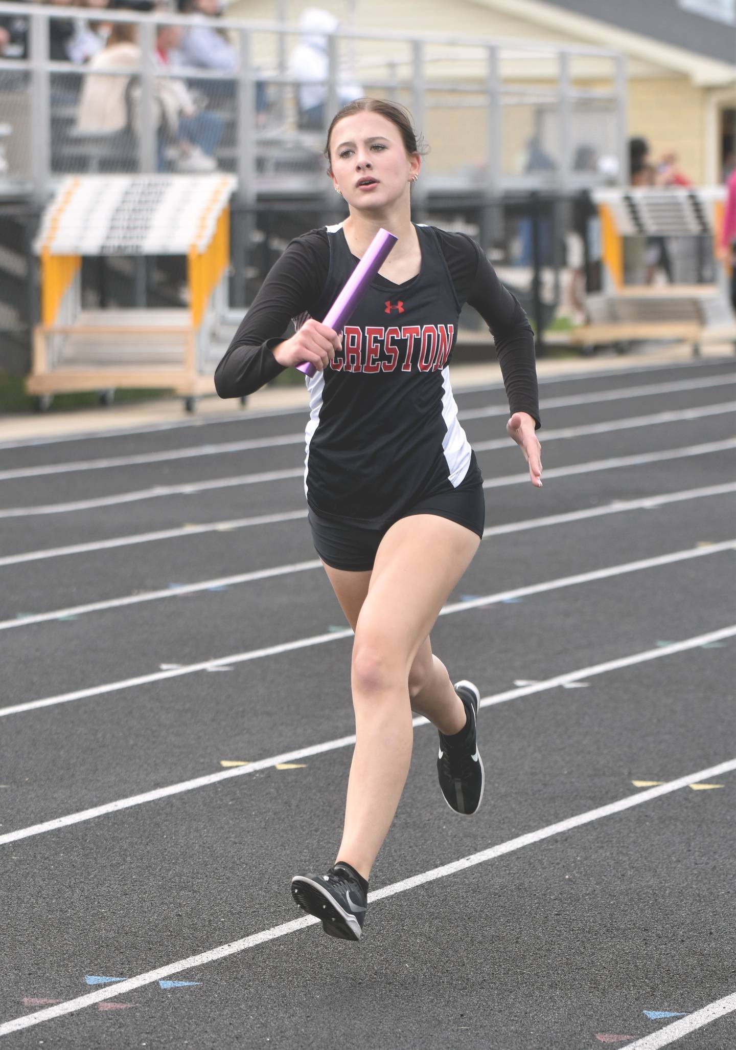 Hope Henderson runs the second leg of the girls 4x800m relay Thursday in Atlantic. The girls qualified with a second-place finish in 10:01.06