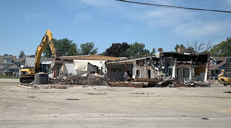 Workers demolish remains of the fire station in Greenfield recently after it was heavily damaged by the tornado May 21.