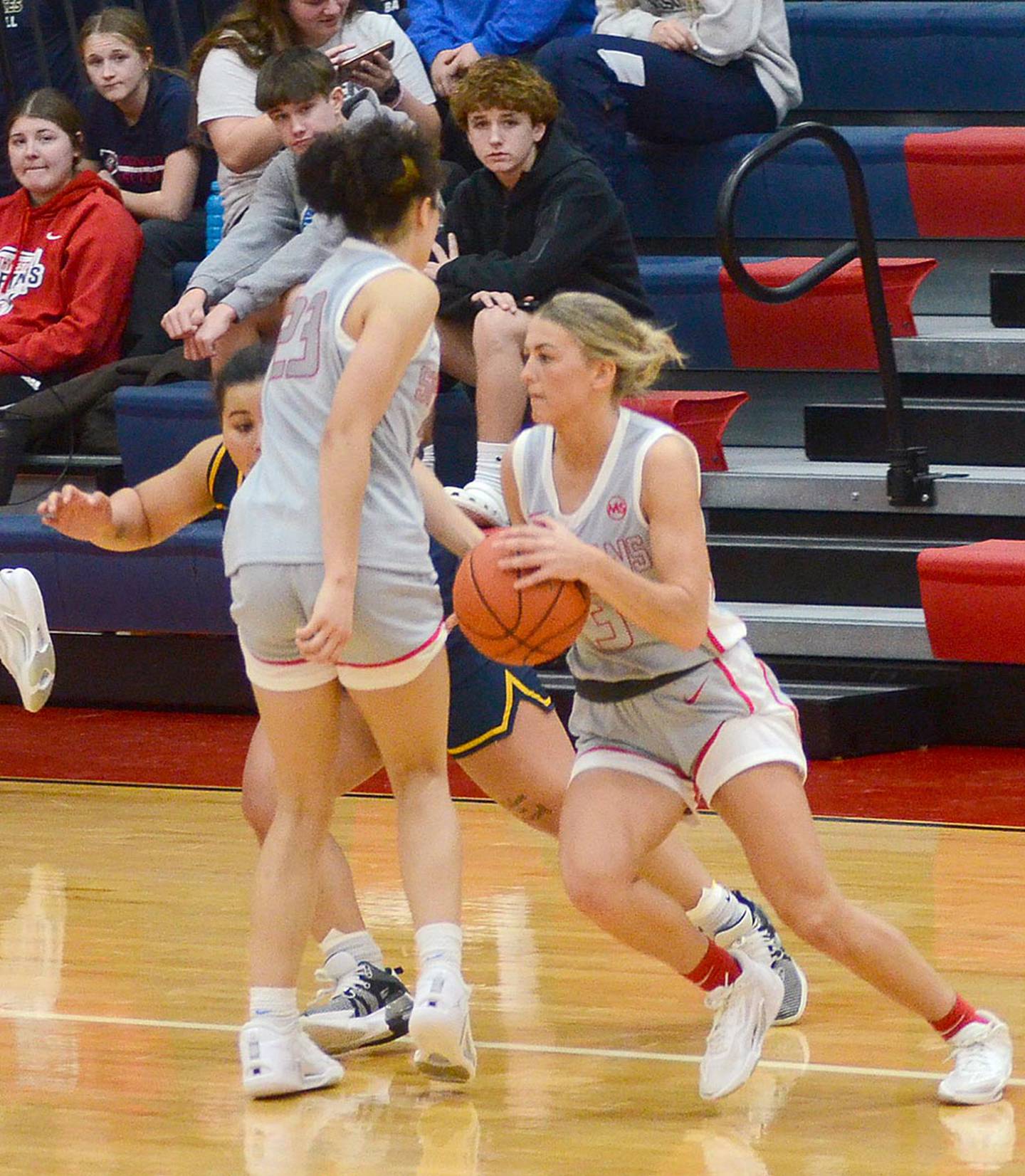 Southwestern guard Cassidy Nelson of Lenox dribbles past the screen of teammate Shyla Moore during Saturday's home game. Nelson scored 15 points in the 75-72 loss to Iowa Lakes.