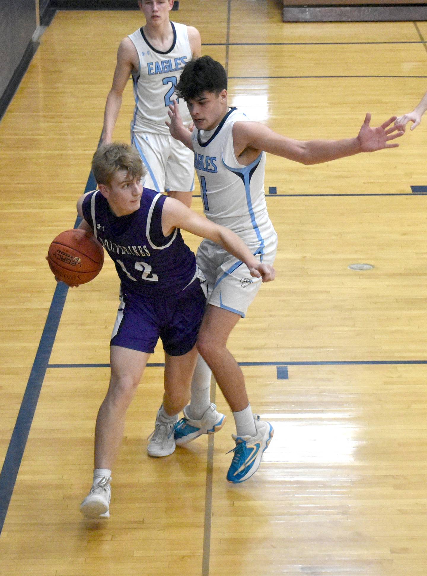 Wolverine junior Ben Hoover faces pressure in the back court from an East Union defender Friday night.