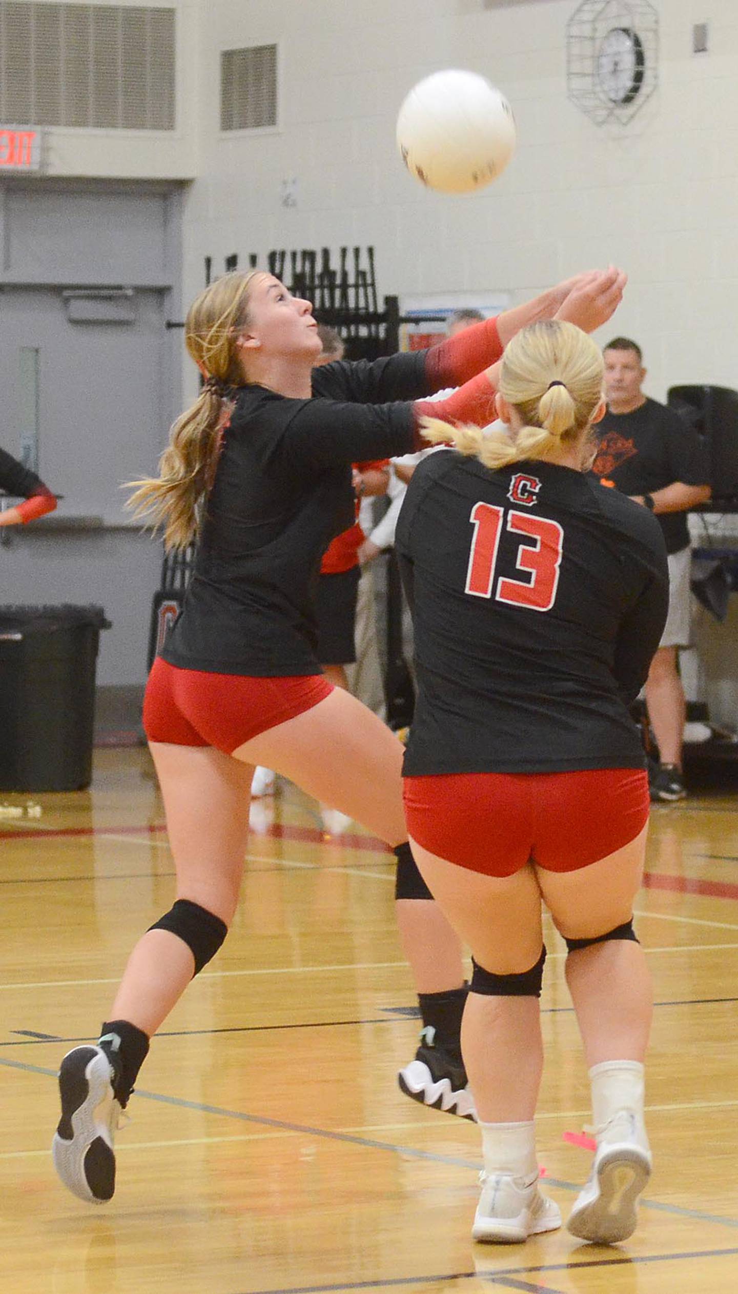 Kolbey Bailey and Jaycee Hanson (13) converge for a save near the back line against Red Oak Thursday. Bailey had five digs and four kills in the 3-0 loss.