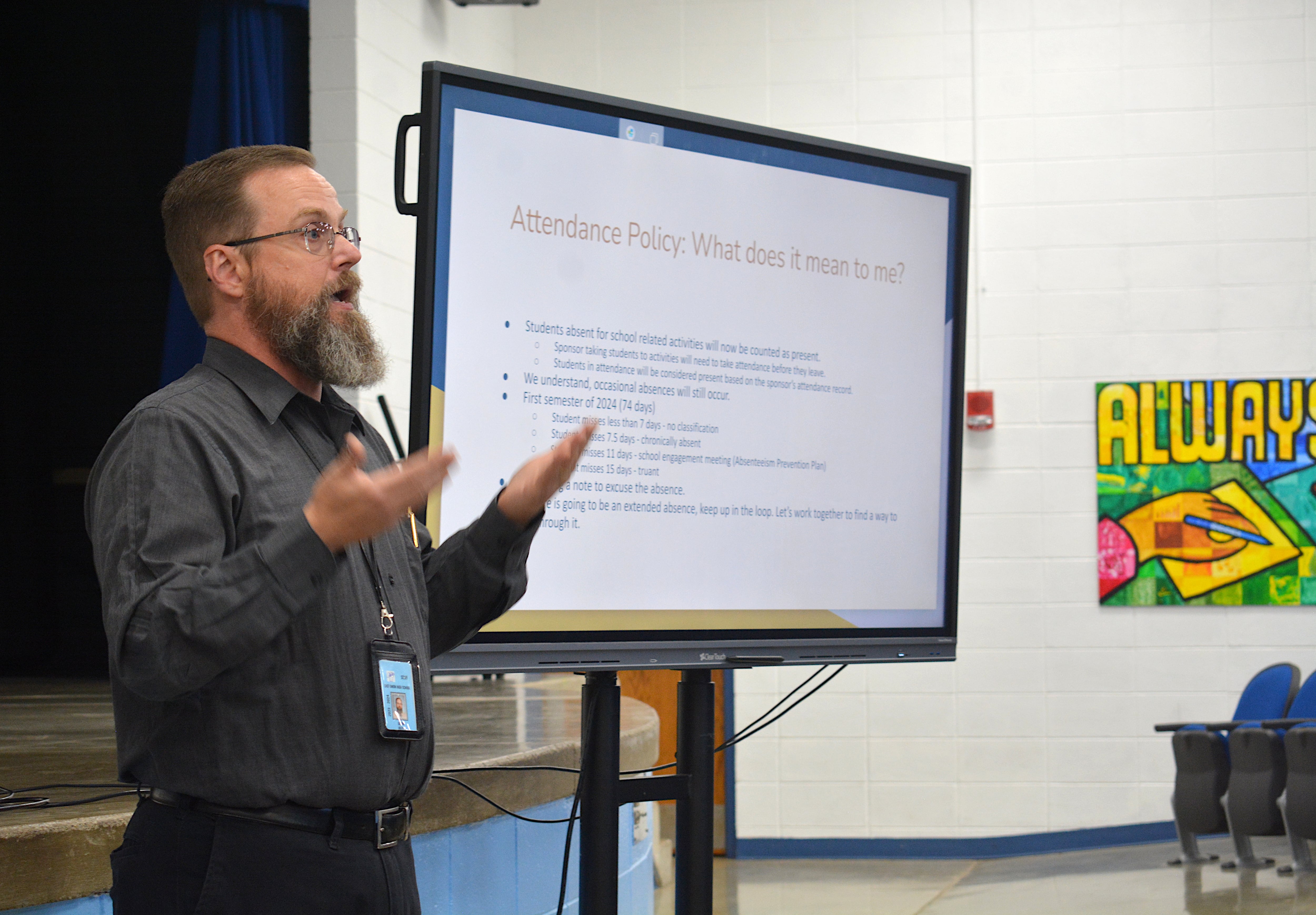 East Union Secondary Principal Jason Riley talks to parents in the East Union auditorium about new attendance policies mandated by Iowa legislators.