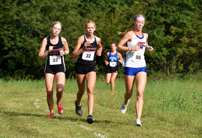 From left, Creston sophomore Reese Strunk and freshman Cora Smith battle at the front with I-35 senior Olivia Phillips. Phillips placed first with Smith in second and Strunk in third.