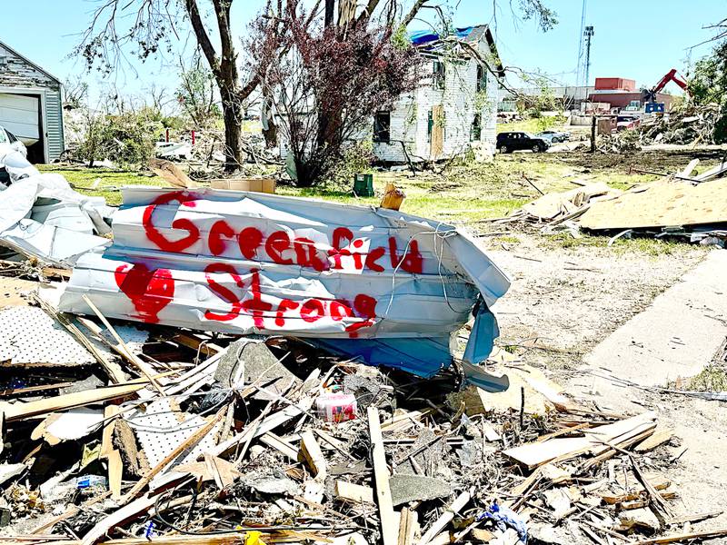 Someone painted "Greenfield Strong" with a heart next to it on a piece of debris from the tornado outside Greenfield Lumber last Saturday.