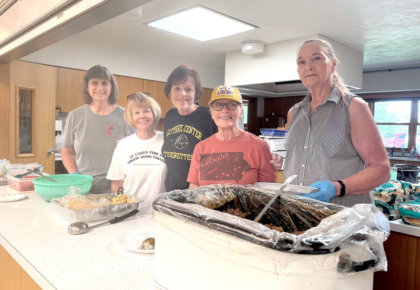 A group of women from Guthrie Center United Methodist Church serve lunch in June at Greenfield United Methodist Church.