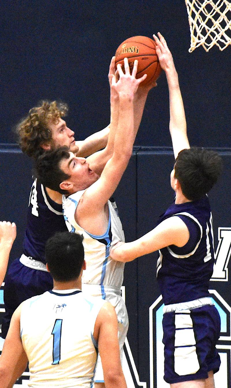 Paul Berg (left) and Jacob Mangels (right) battle for a rebound against East Union in the first round of Class 1A district tournament action.