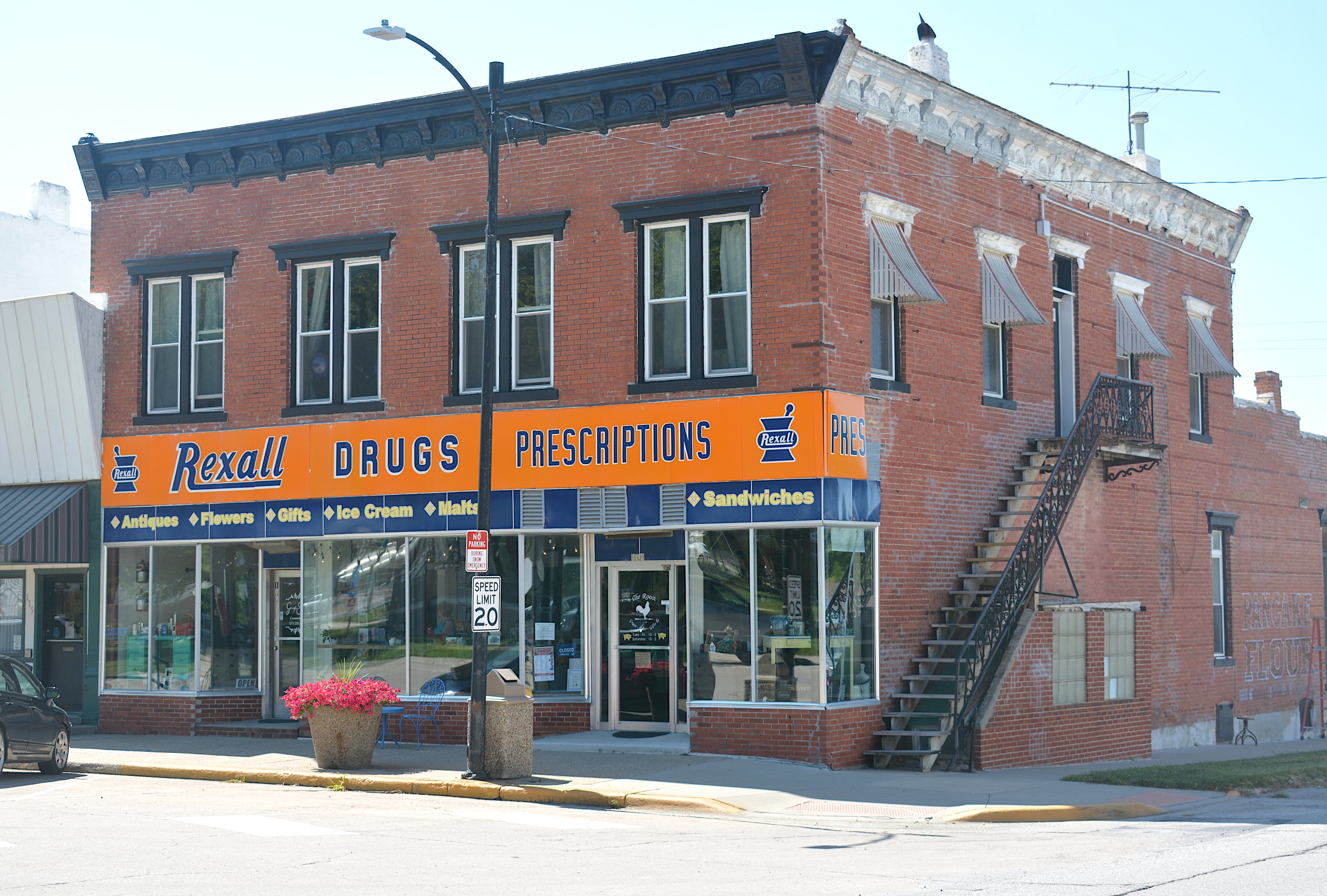 The building which houses The Roost, located at 101 E. Kansas Street. The banners above the doorways are from previous businesses of the building, including Rexall Drugs and a banner from The Purple Cow.