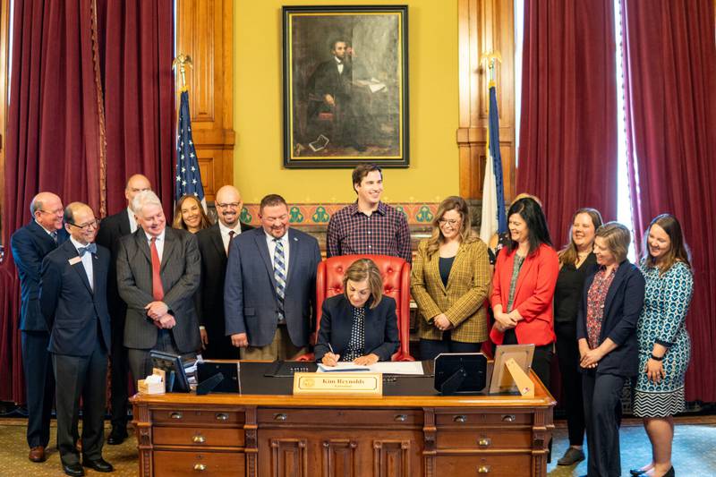 Gov. Kim Reynolds signs into law a bill giving more control to community college leaders in May after working with Community Colleges for Iowa. SWCC President Lindsay Stoaks is present, along with other Iowa community college presidents.