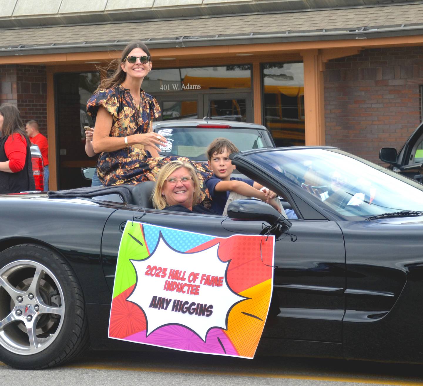 Hall of Fame inductee Amy Higgins waves to the crowd during Friday's homecoming parade.