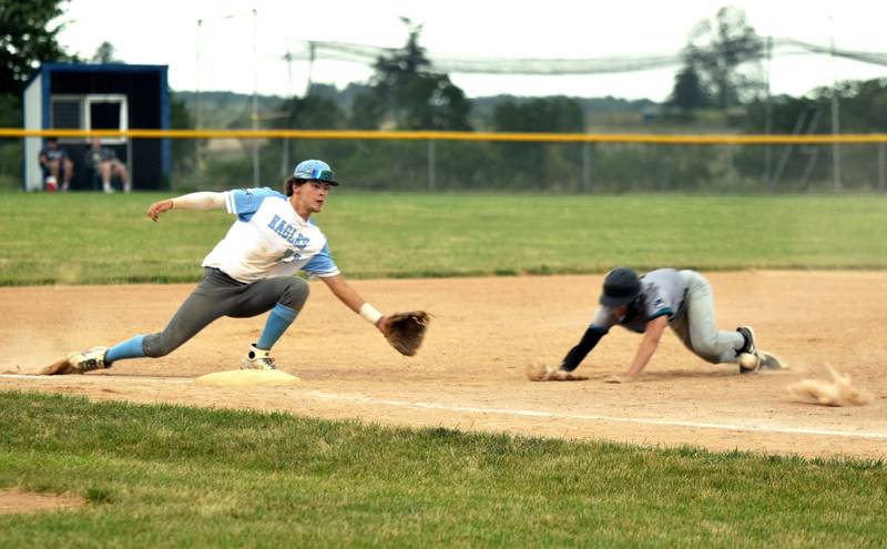 Southwest Valley freshman Walker Bissell dives for third base Monday in a 12-11 loss in extra innings to East Union. Eagles third baseman Fischer Buffington keeps a foot on base as he reaches for the ball.