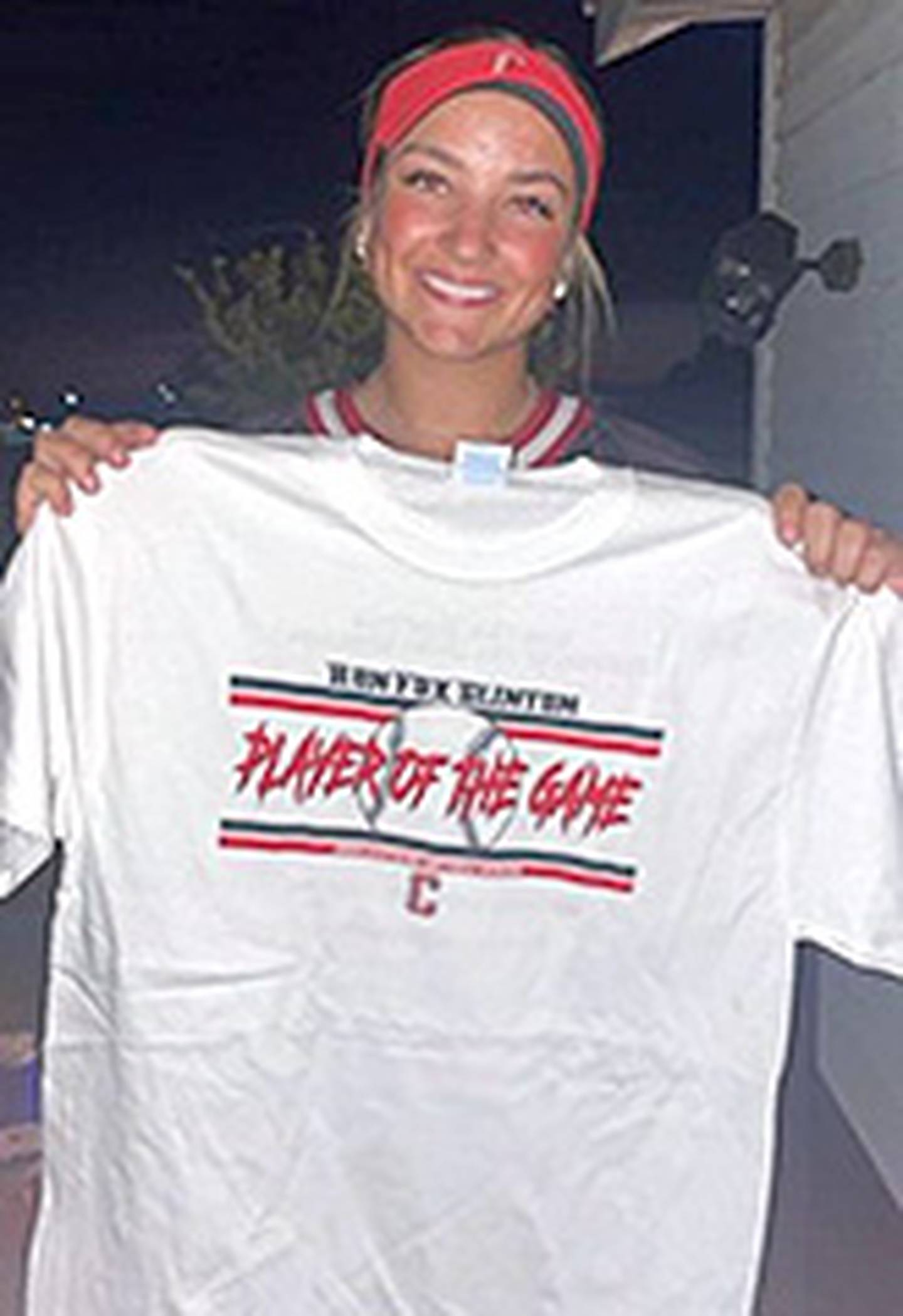 Creston's Jersey Foote shows the Ron "Fox" Clinton Player of the Game T-shirt she received after hitting a grand slam home run in a 6-5 win over Earlham Saturday night.